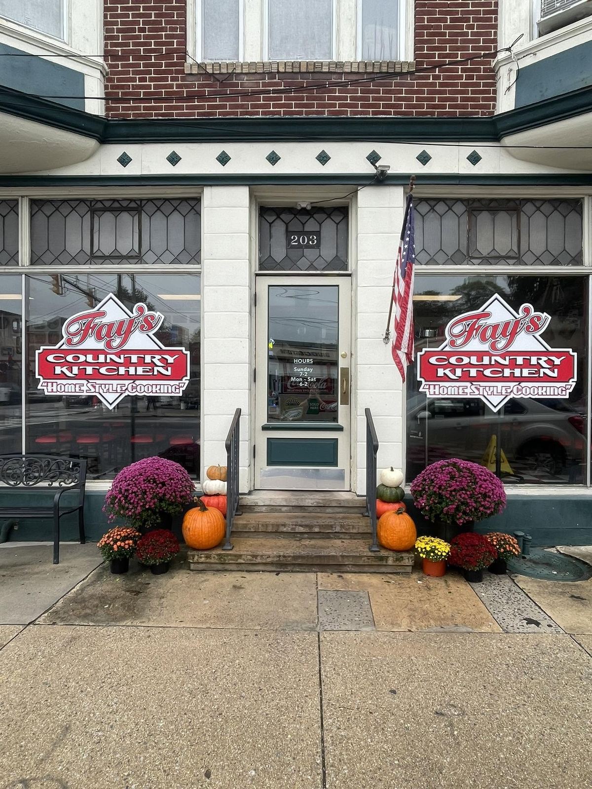 Fay's Country Kitchen storefront at 203 S Hanover St, with autumn mums and pumpkins